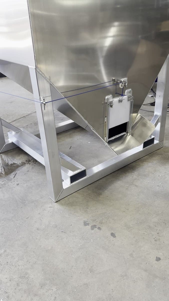 Aluminum gravity feeder filler — a large hopper on an A-frame stand with a bottom fill gate.