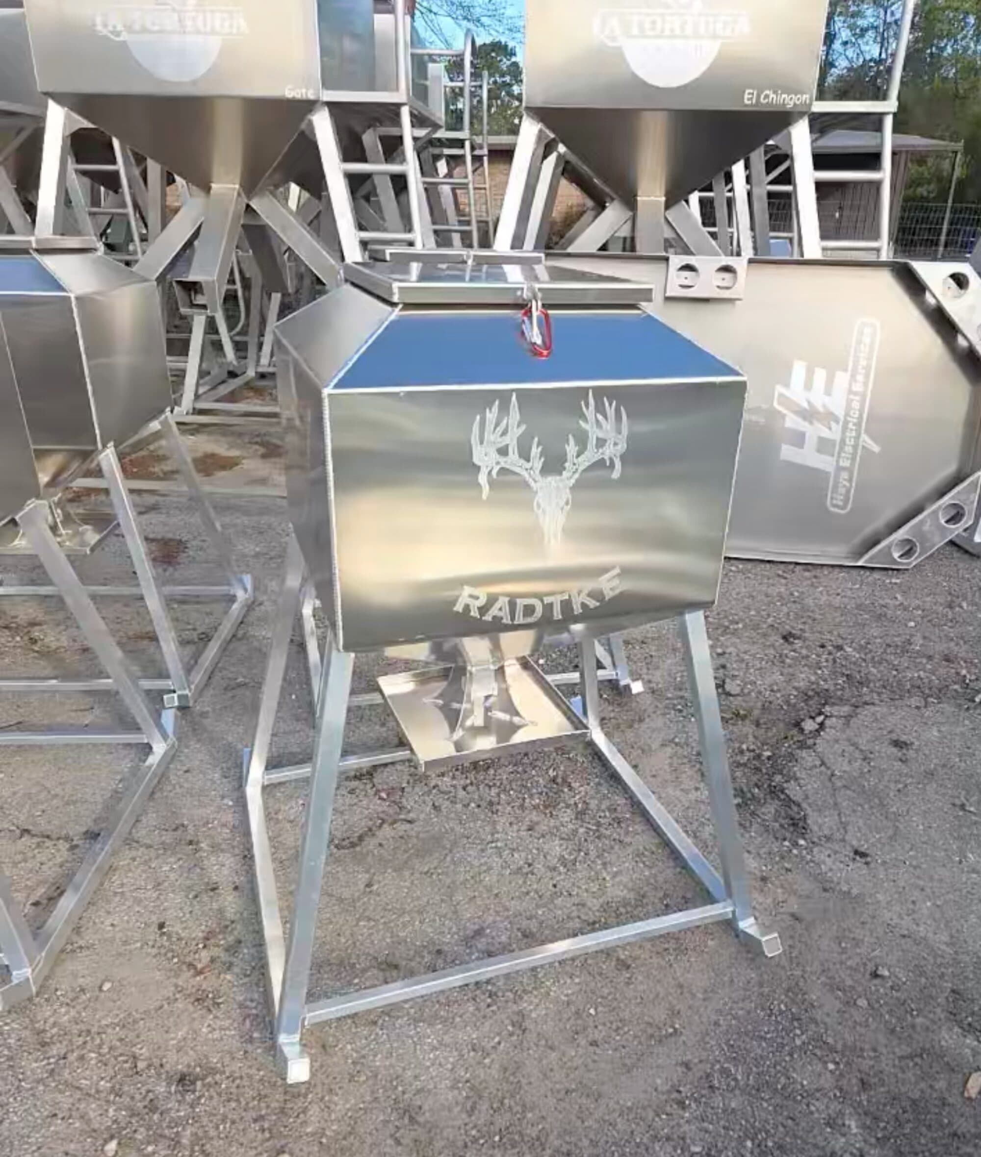 Aluminum turkey feeder on a welded stand, laser-engraved with a customer's ranch brand — every order is engraved with your logo.